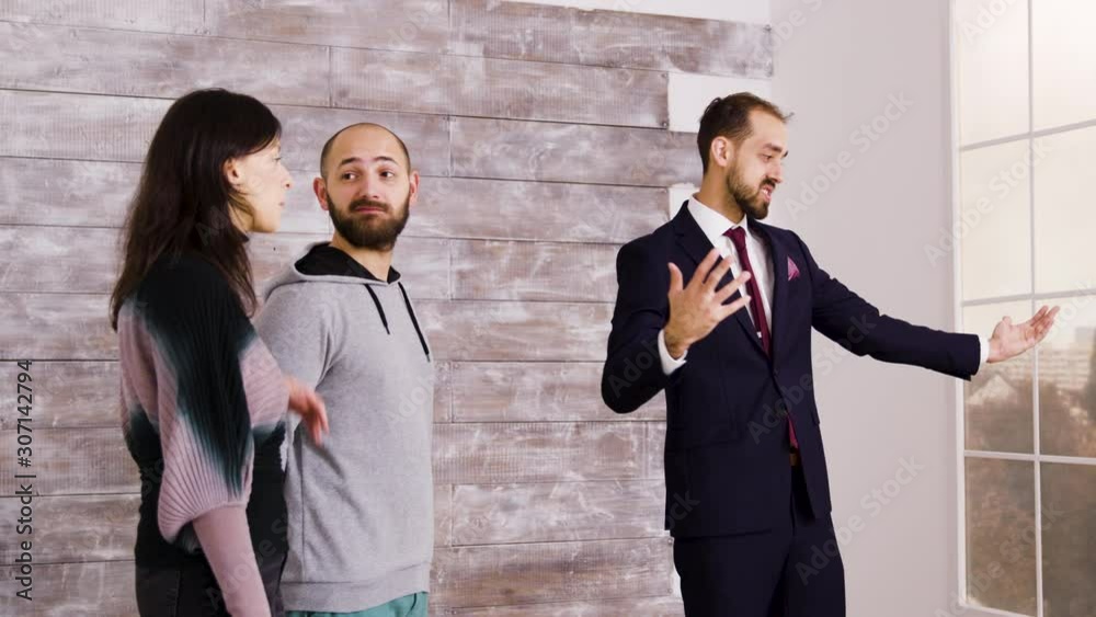 Real estate agent in suit presenting new apartment Real estate agent in suit presenting new apartment