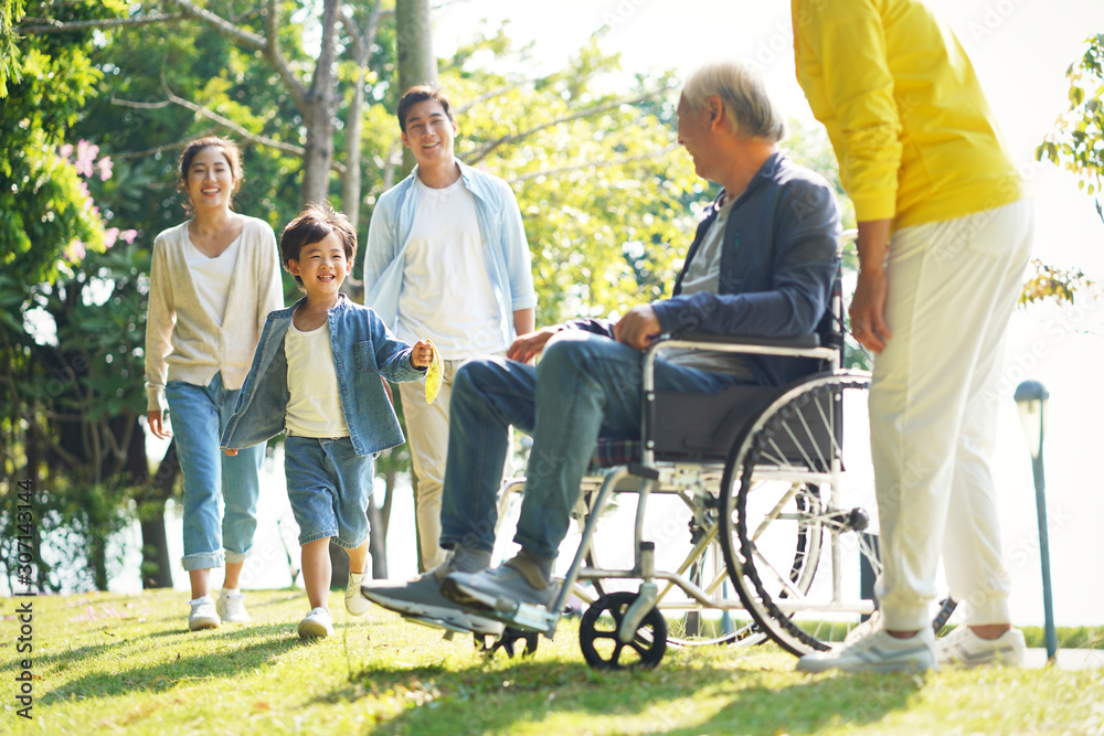 happy three generation asian family having fun in park happy three generation asian family having fun in park