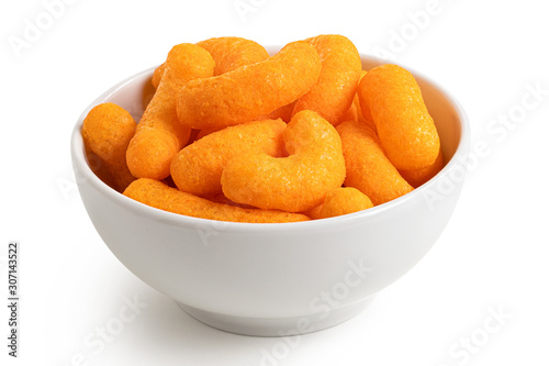 Extruded cheese puffs in a white ceramic bowl isolated on white.