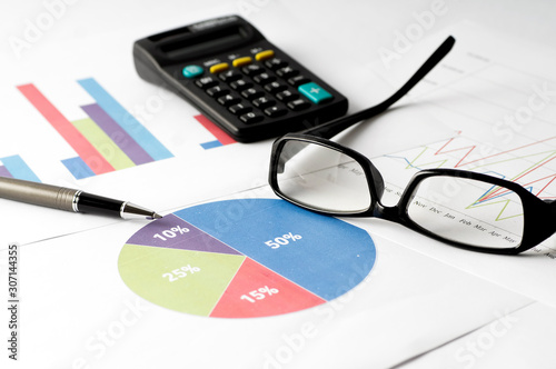 Business Analysis report with graph chart, glass and calculator for annual report
