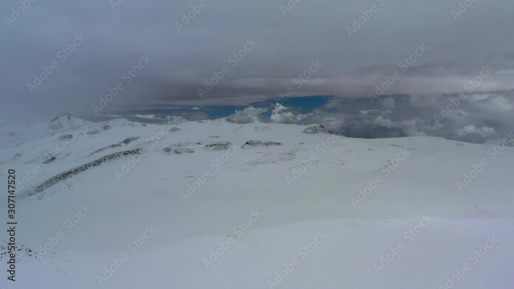 Aerial view from right to left of white snow panorama with low clouds Aerial view from right to left of white snow panorama with low clouds