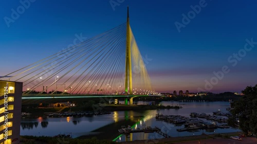 Day to night time lapse of Ada suspension bridge in Belgrade photo