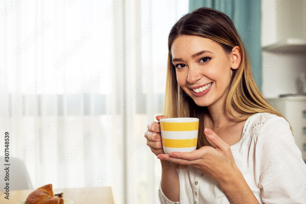 Smiling happy woman holding cup and looking at camera Smiling happy woman holding cup and looking at camera