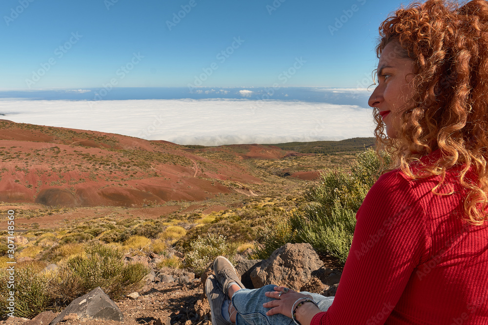 girl dressed in red watching the views in El Teide National Park in Tenerife, Canary Islands, Spain girl dressed in red watching the views in El Teide National Park in Tenerife, Canary Islands, Spain