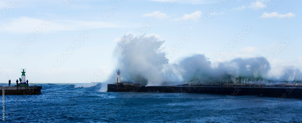 Waves crashing over harbour wall, Cape Town