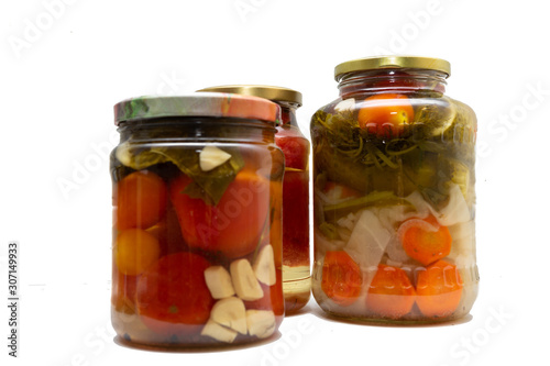 Homemade canned food in glass jars on a white background. Pickled organic food.