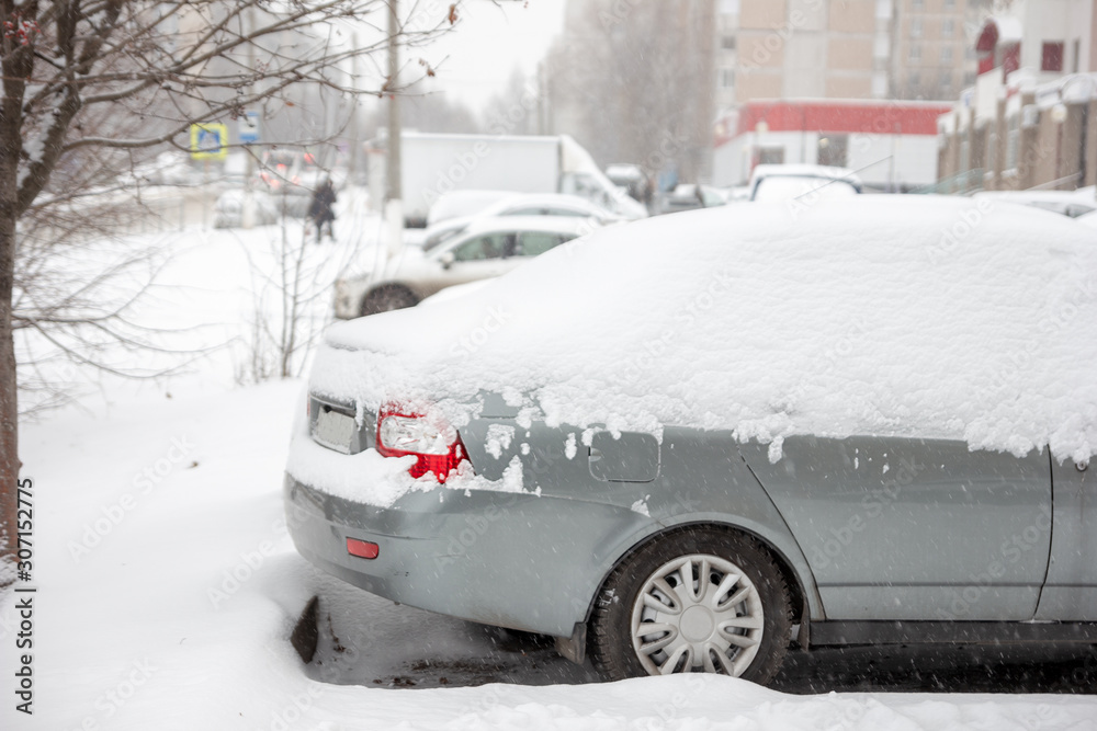Cars swept by the snow parked on the side of the road. Winter background outdoors. Snowy weather. Cars swept by the snow parked on the side of the road. Winter background outdoors. Snowy weather.