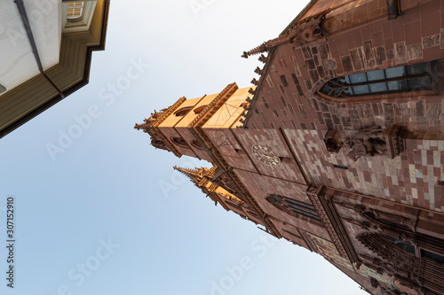 Switzerland, Basel, Muensterplatz, 3rd of August 2019. The medieval Basel church with twin towers made from red sandstone photo