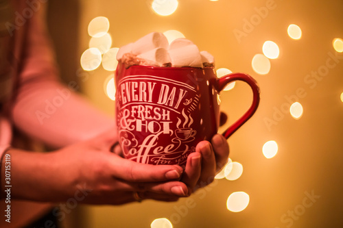 Photo of a cup with a drink and with marshmallows and Christmas candy