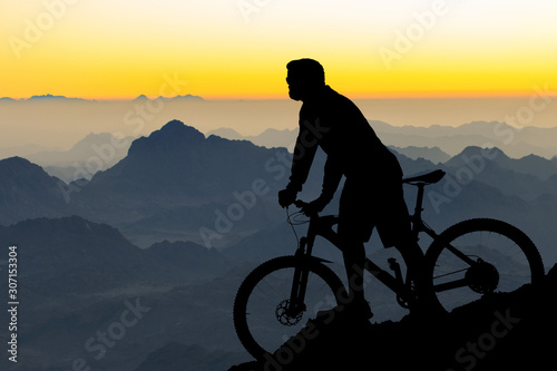 Athletic young guy in glasses and a helmet looks into the distance. Toned panoramic image. © Mountains Hunter
