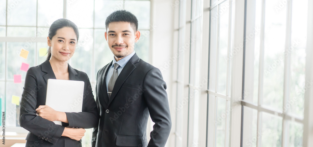 Beautiful asian business man and woman looking in laptop in office and happy.Asian business adviser meeting to analyze and discuss the situation.Investment Consultant,Financial Consultant. Beautiful asian business man and woman looking in laptop in office and happy.Asian business adviser meeting to analyze and discuss the situation.Investment Consultant,Financial Consultant.