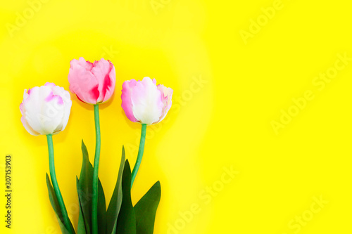 Fototapeta Naklejka Na Ścianę i Meble -  natural decorative pink tulips with green leaves for women's day