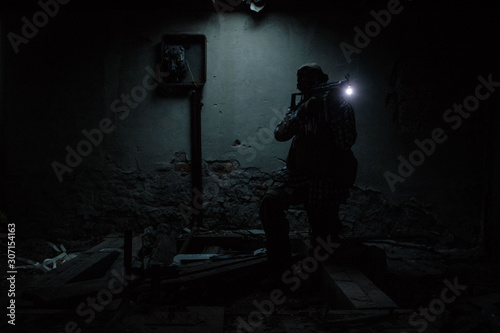 airsoft player in dark abandoned room