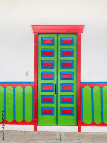 Colorful door of a traditional house of Salento in Colombia wit
