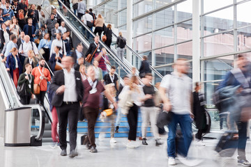 Many people on escalator at business trade fair