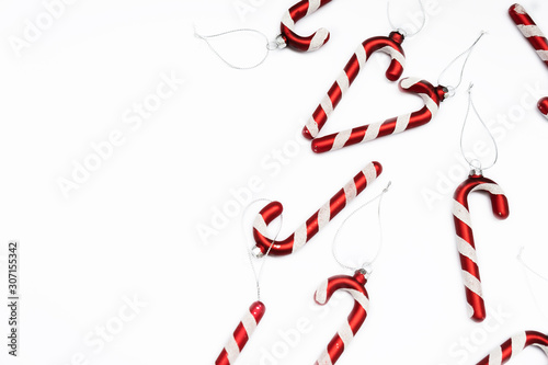 Christmas composition. Border made of red decorations on white background.