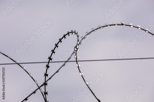 Barbed wire on the sky background. metal wire. selective focus