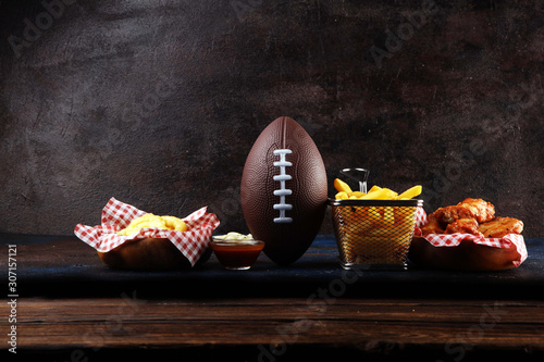 chicken wings, fries and onion rings for football on a table. Great for Bowl Game party © beats_