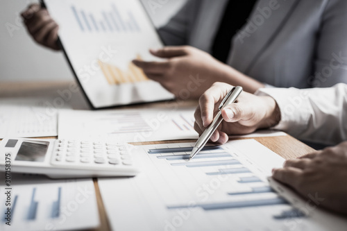 Meeting a team of businessmen, Executives and accountants meeting about the company's revenue graph in the office with laptops and calculators, Finance concept