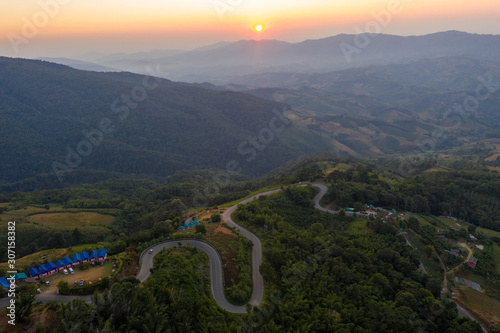 Aerial view of cars driving curves on the mountains and beautiful roads suitable for holiday travel in chiangrai, thailand