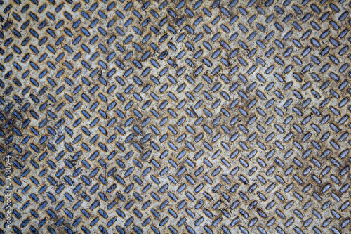 old white rusty metal plate with blue diagonal relief. rough surface texture