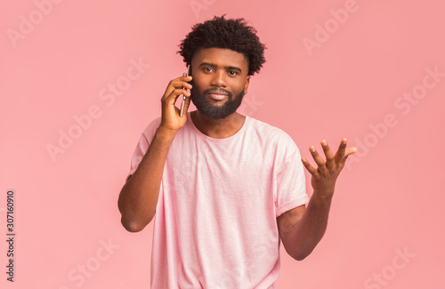 Emotional african american man talking on mobile phone