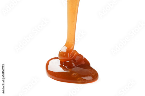 Pouring brown caramel isolated on white background