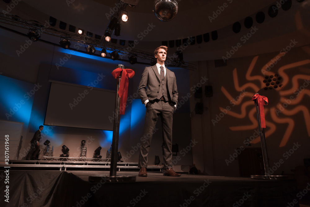 male model showing off business suit during fashion show