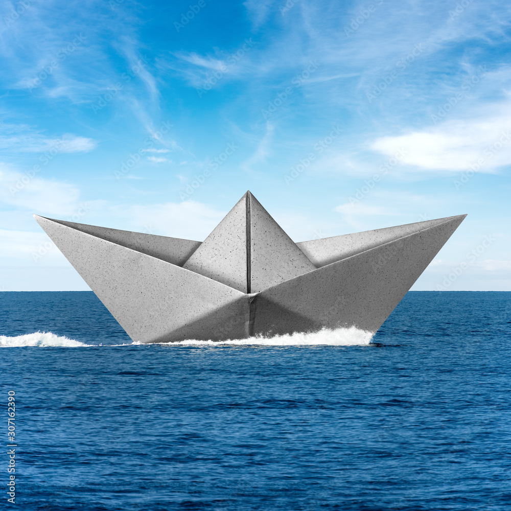 White paper boat runs fast over the blue sea with wake, sky with clouds on the background