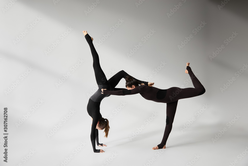 Young women practicing acroyoga in studio Young women practicing acroyoga in studio
