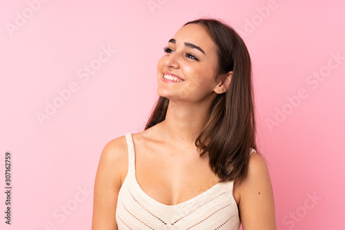 Portrait of beautiful girl over isolated pink background