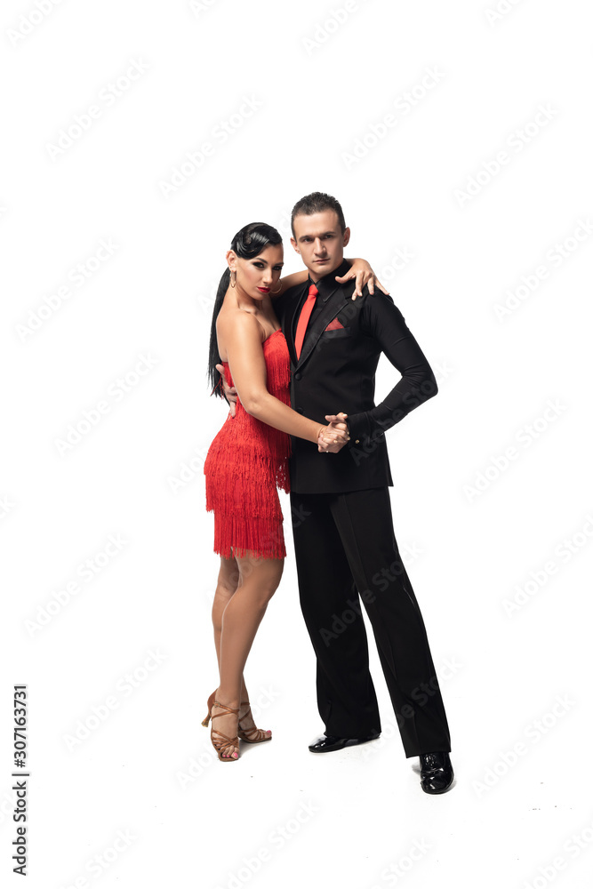 stylish couple of dancers looking at camera while performing tango on white background stylish couple of dancers looking at camera while performing tango on white background