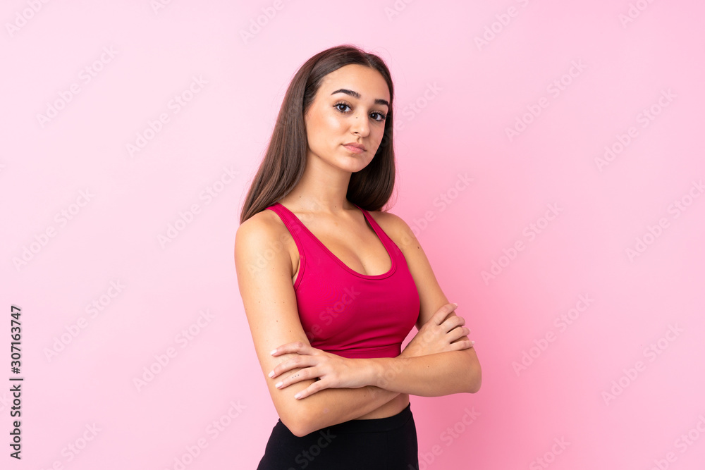 Young sport girl over isolated pink background keeping the arms crossed Young sport girl over isolated pink background keeping the arms crossed