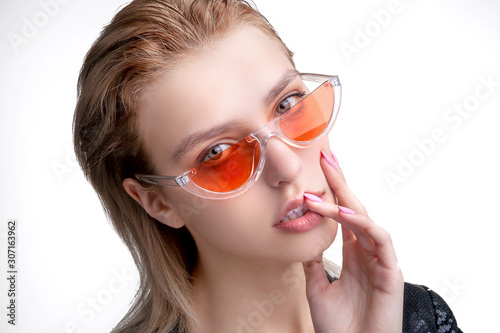 blonde girl in pink glasses closeup