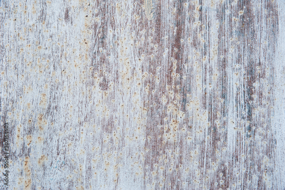 Streaks of white paint and rust stains on the old, brown, tattered metal surface. Abstract background, texture. Streaks of white paint and rust stains on the old, brown, tattered metal surface. Abstract background, texture.