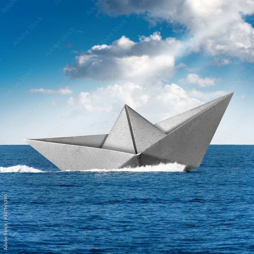 White paper boat runs fast over the blue sea with wake, sky with clouds and sun rays on the background