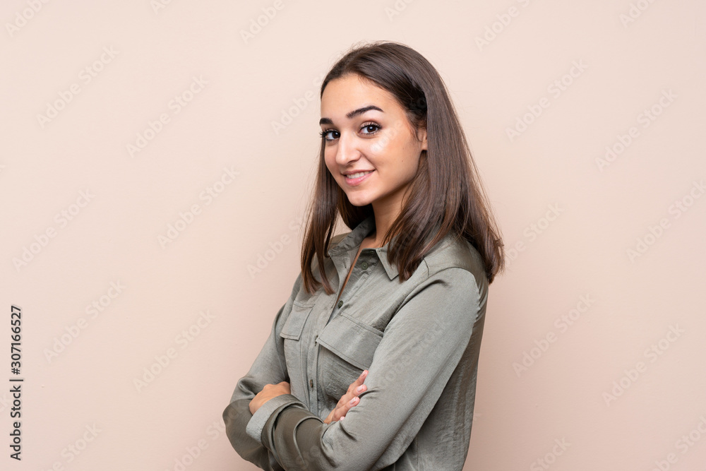 Young girl over isolated background with arms crossed and looking forward Young girl over isolated background with arms crossed and looking forward