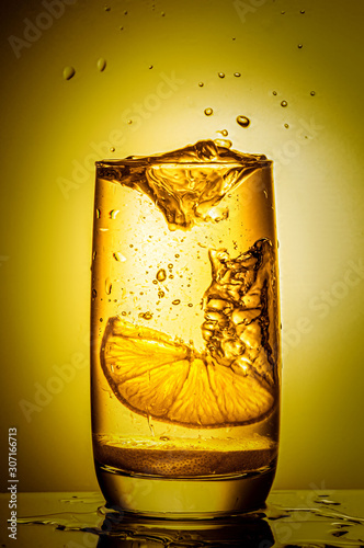 splash with lemon in a glass photo