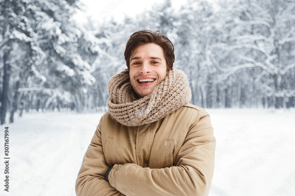 Attractive Man Smiling At Camera Posing In Snowy Forest Attractive Man Smiling At Camera Posing In Snowy Forest
