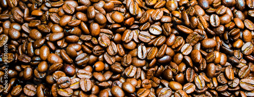 Close up roasted coffee beans background for banner © dharmapocan