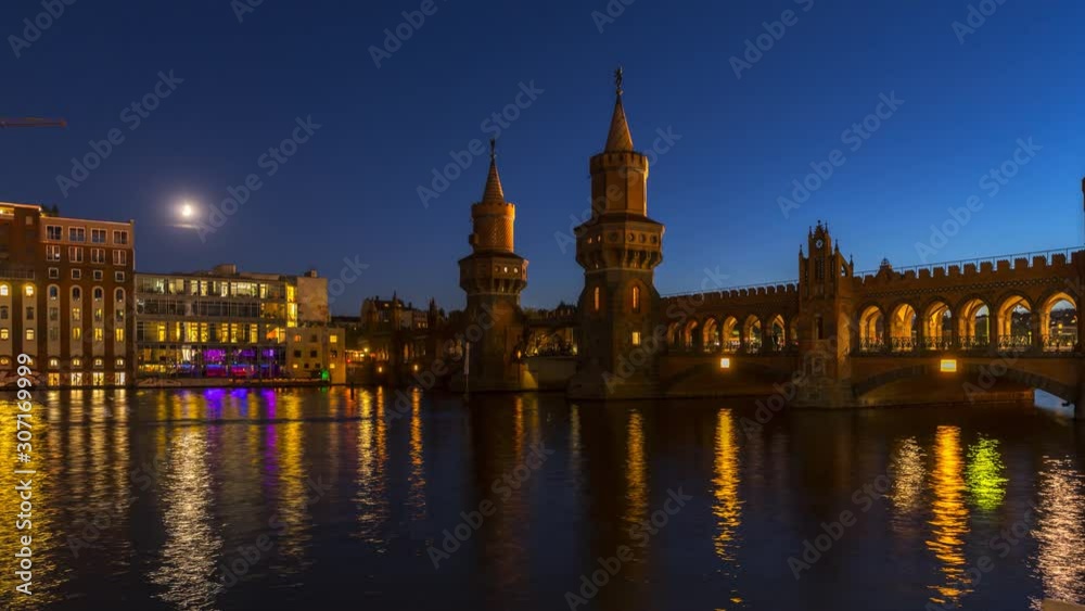 The Oberbaum Bridge is a double-deck bridge crossing Berlin's River Spree, considered one of the city's landmarks. Time lapse video of berlin at night. The Oberbaum Bridge is a double-deck bridge crossing Berlin's River Spree, considered one of the city's landmarks. Time lapse video of berlin at night.