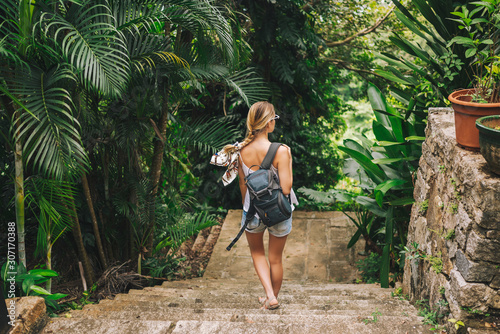 Traveler blonde backpacker woman walking and discovering jungle tropical park, Travel adventure nature in China, Tourist beautiful destination Asia, Summer holiday vacation journey trip concept