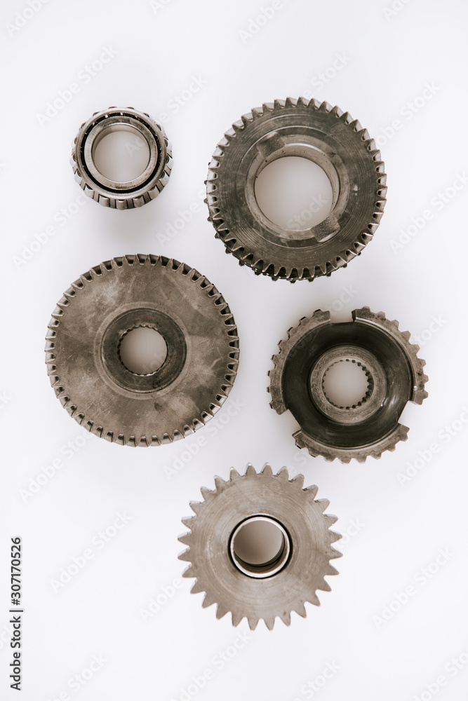 top view of metal round gears on white background top view of metal round gears on white background