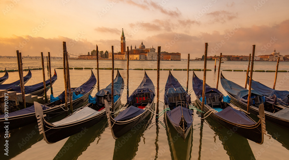 Gondolas moored in St. Mark's Square, San Giorgio Maggiore church in the background, Venice, Italy