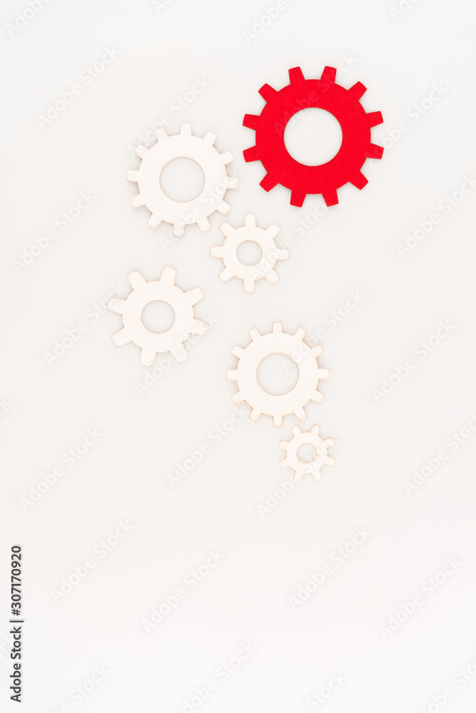 top view of one red gear among another isolated on white top view of one red gear among another isolated on white