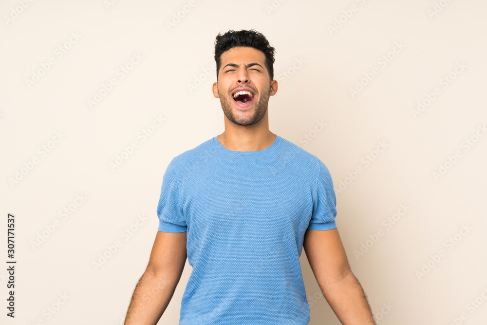 Young handsome man over isolated background shouting to the front with mouth wide open Young handsome man over isolated background shouting to the front with mouth wide open