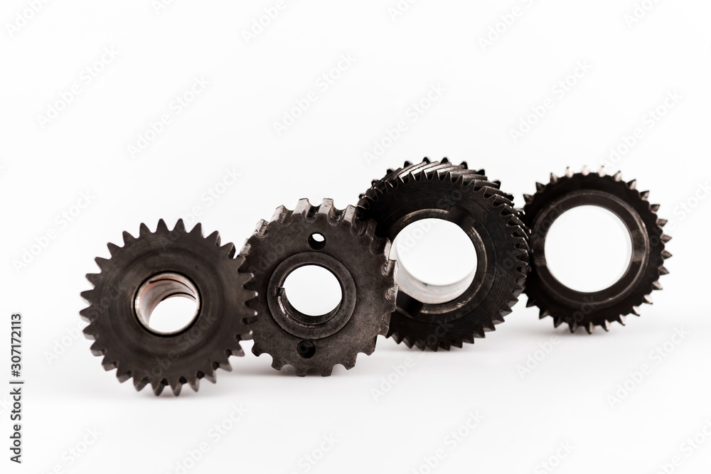 metal round gears in row on white background metal round gears in row on white background