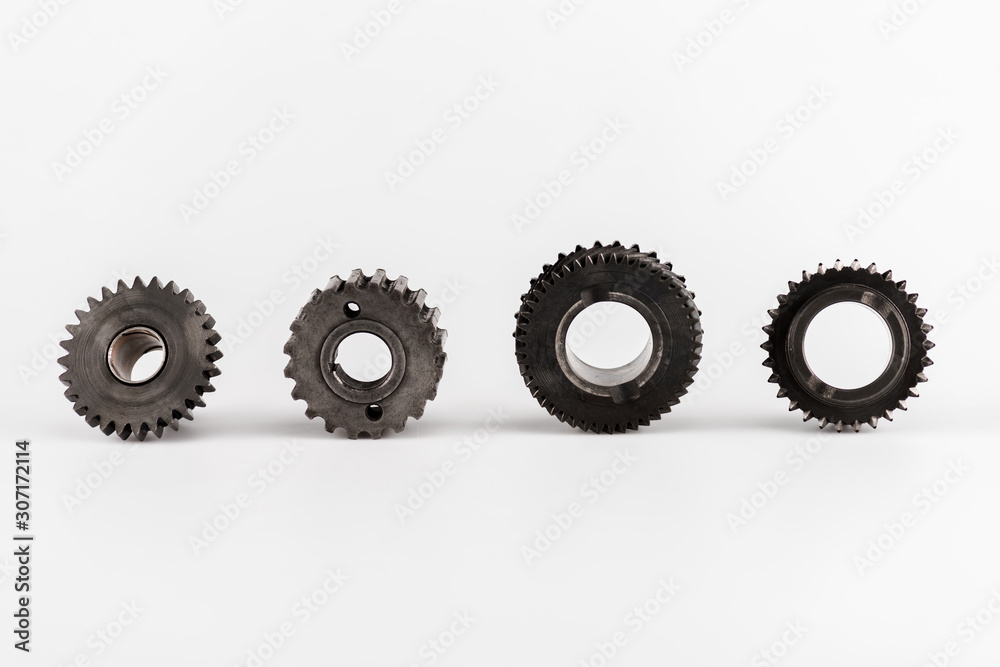 metal round gears in row on white background metal round gears in row on white background
