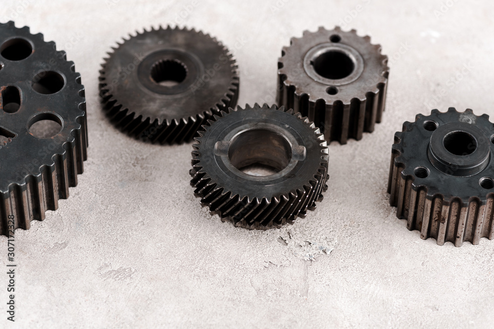 metal round gears on grey background metal round gears on grey background