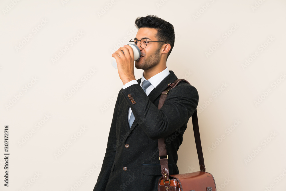Young handsome businessman man holding coffee to take away over isolated background Young handsome businessman man holding coffee to take away over isolated background